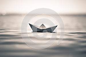 Aper boat on sea waves. toned image of paper boat.