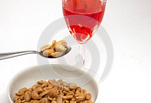 Aperitif with peanuts and red alcoholic beverage