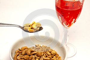 Aperitif with peanuts and red alcoholic beverage photo