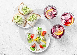 Aperitiv table - select and snack, top view. Sandwiches with avocado, canapÃ© with mozzarella, tomatoes, oliv