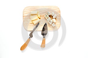 Aperitive parmesan cheese and cheese with blue mould on a cutting board on white background top view