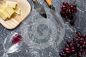Aperitive parmesan cheese and red grape on grey stone table background copyspace top view photo