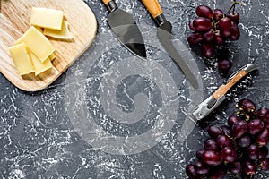 Aperitive parmesan cheese and red grape on grey stone table background copyspace top view