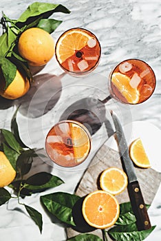 Aperol Spritz cocktail in glasses with oranges, top view