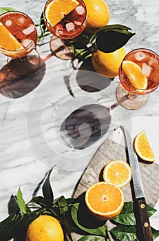 Aperol Spritz cocktail in glasses with oranges, top view, copy space