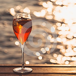 Aperol spritz at a wooden pier at sunset. Luxury resort vacation