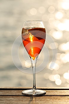 Aperol spritz at a wooden pier at sunset. Luxury resort vacation