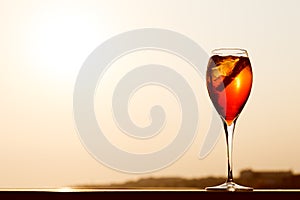 Aperol spritz at a wooden pier at sunset. Luxury resort vacation