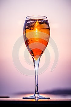 Aperol spritz at a wooden pier at sunset. Luxury resort vacation