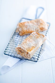 Apfelstrudel or apple strudel on a wire rack