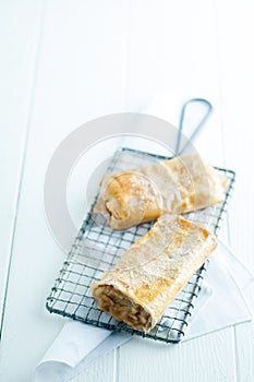 Apfelstrudel or apple strudel on a wire rack