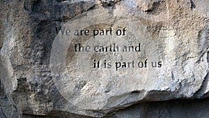 Aphorism carved into rock boulder