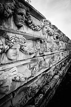 Aphrodisias Afrodisias Ancient City in Caria, Karacasu, Aydin, Turkey. Ancient wall, relief and masks. photo