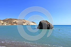 Aphrodite Beach with Stone Rocks in Aphrodite bay of Mediterranean sea water, blue sky in sunny day background, Petra tu Romiou, photo