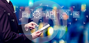 API - application programming interface concept with businessman using a tablet computer