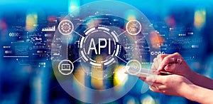 API - application programming interface concept with person using a smartphone at night