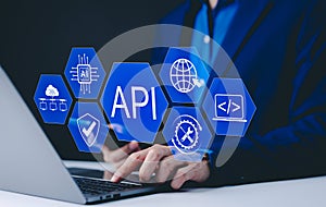 API Application Programming Interface Concept. A programmer types on a laptop, interacting with digital icons representing API