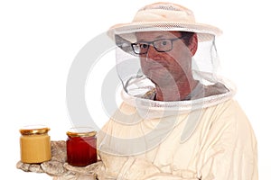 Apiarist with honey glasses in hands