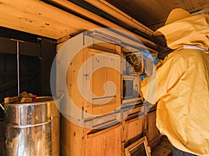 Apiarist putting hive frames on the beekeeping frame holder