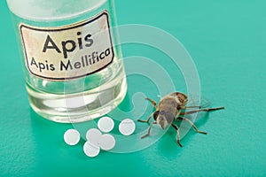 Apis Mellifica homeopathic pills, poison and bee photo