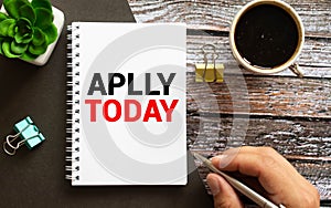 Aplly today. Content. text on blue sticker on table button holds sticker