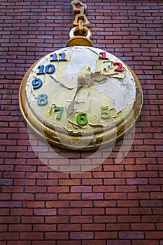 Apocalypse concept - Decorative pocket clock on a red bricks wall with peeled paint
