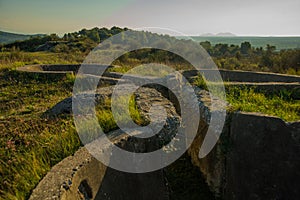 APOLLONIA, ALBANIA: Landscape with the military bunkers in the middle of a rural fields near Apollonia.