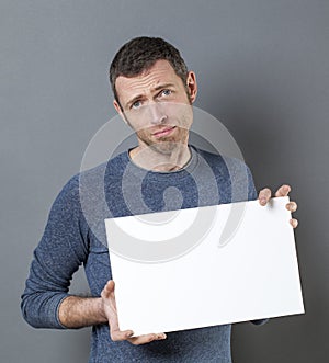 Apologetic man holding blank crad for your advert