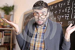 Apologetic teacher in math class photo
