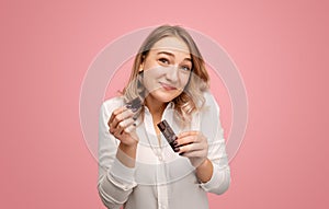 Apologetic young woman with chocolate photo