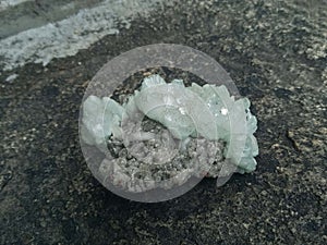 Apophyllite  Green crystals on natural rock  background.