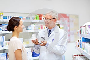 Apothecary and woman with drug at pharmacy