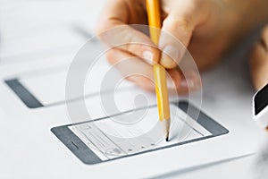 Web designer hand creating user interface layout