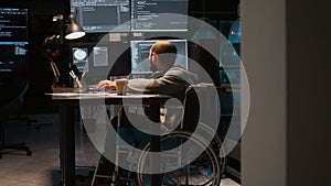 App developer with physical disability working on IT software coding