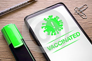 App for vaccinate with covid 19 virus with notification green vaccinated on the phone screen. smartphone application for