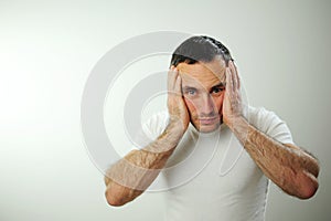 Appalled man emotional guy feeling sinking heart shortness of breath about emotional stress sensations isolated on grey