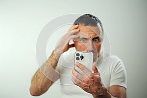 Appalled man Look at phone emotional guy feeling sinking heart shortness of breath emotional stress sensations isolated