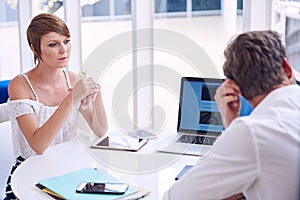 Apparent disagreement between male and female partners during business meeting