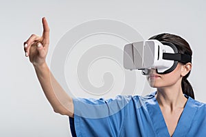 Appealing female doctor touching virtual object