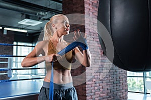 Appealing strong sportswoman working out in gym