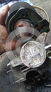 the appearance of a damaged motorcycle piston and cylinder block