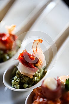 Appetizer with bacon and pesto in a spoon