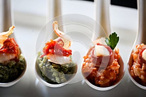 Appetizer with bacon and pesto in a spoon