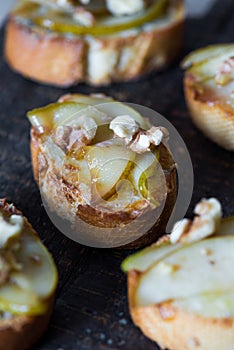 Appetizer bruschetta with pear, honey, walnut and blue cheese