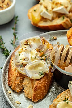 Appetizer bruschetta with pear, honey, walnut and thyme, New Years Eve or Christmas party, vertical image. top view. place for