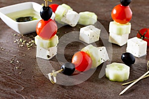 Appetizer canape. Greek salad with fresh vegetables, feta cheese and olives