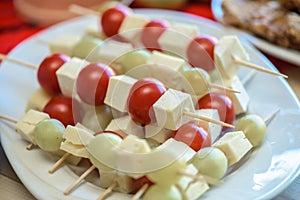 Appetizer with cheese, tomatoes and grapes