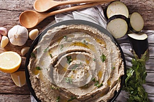 Appetizer of eggplant baba ghanoush closeup in a plate. Horizontal top view photo