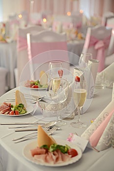 Appetizer a ham and a beautiful table setting at a wedding