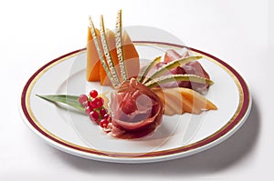 Appetizer Parma ham and melon with currants